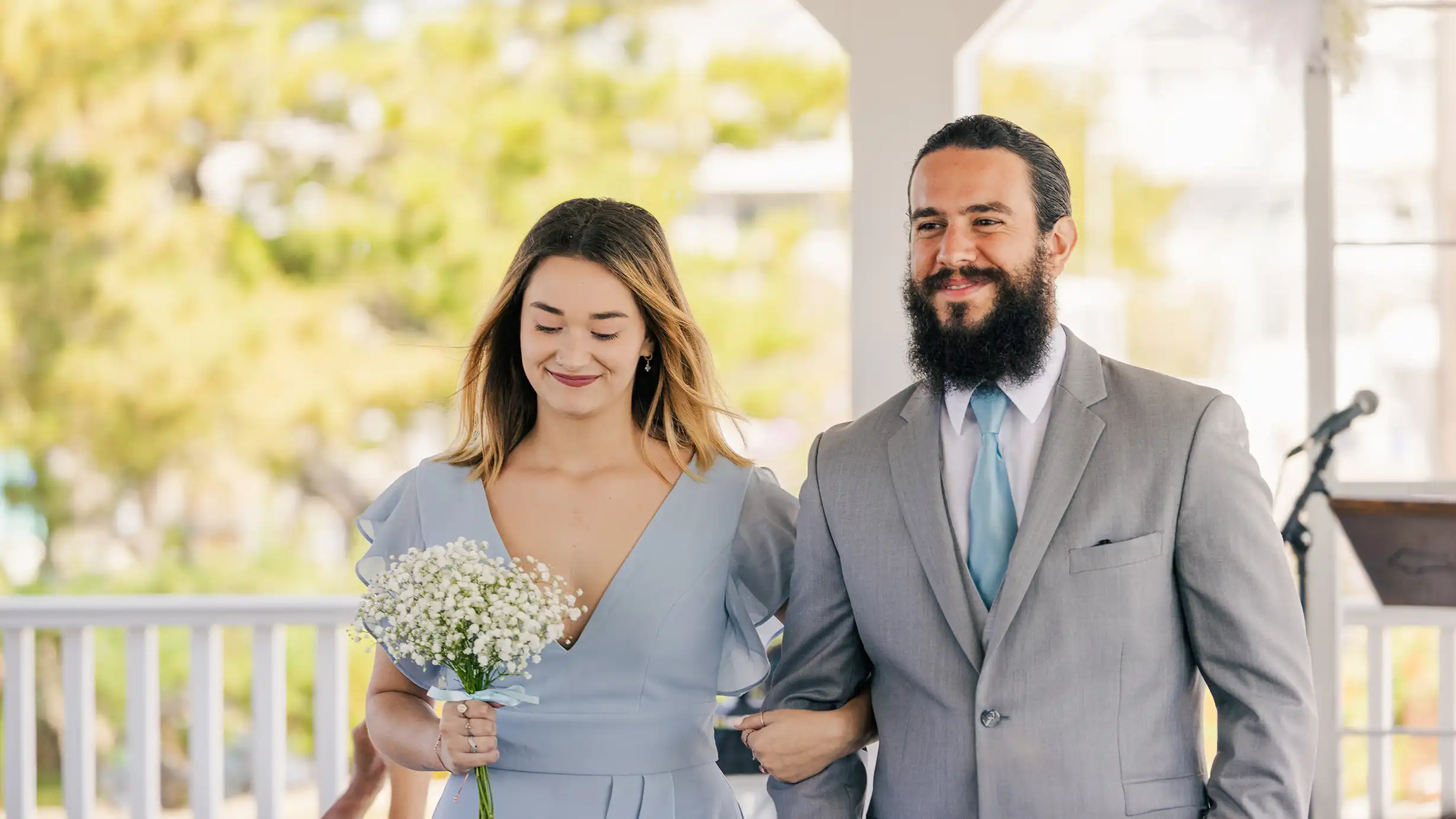 Elated bridesmaid and groomsman walk down the aisle, celebrating the happy couple.