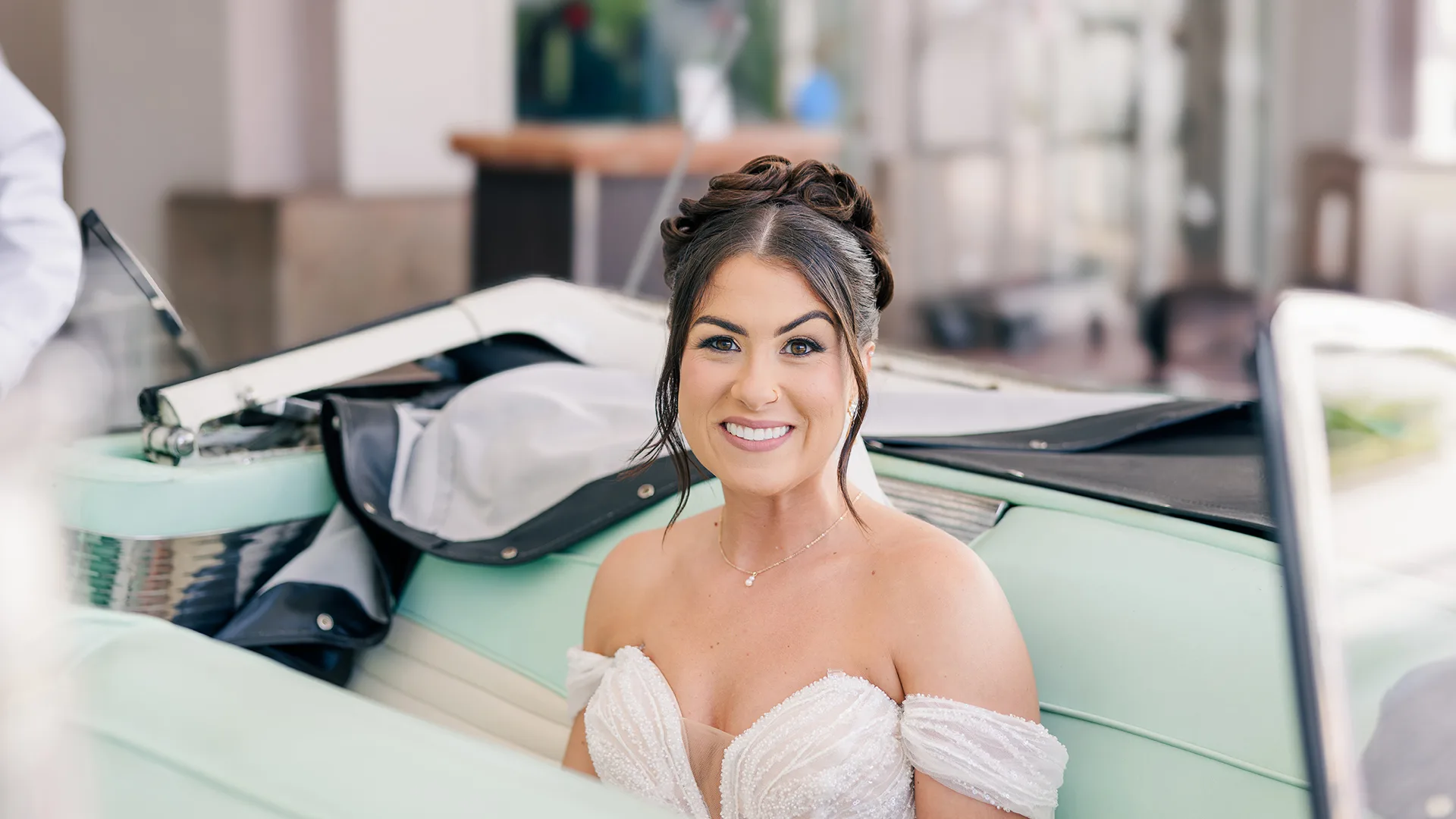 A bride seated in a classic car ready to meet the groom for their first look in beautiful Puerto Rico before their wedding ceremony.