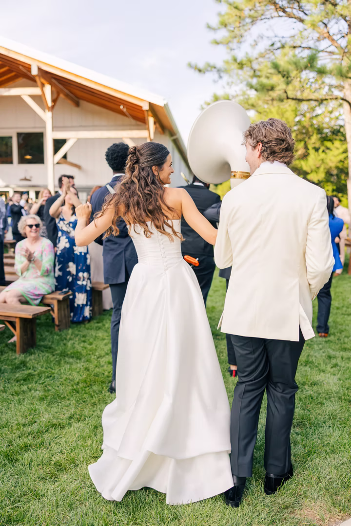 bride-groom-dancing-band-parade-reception