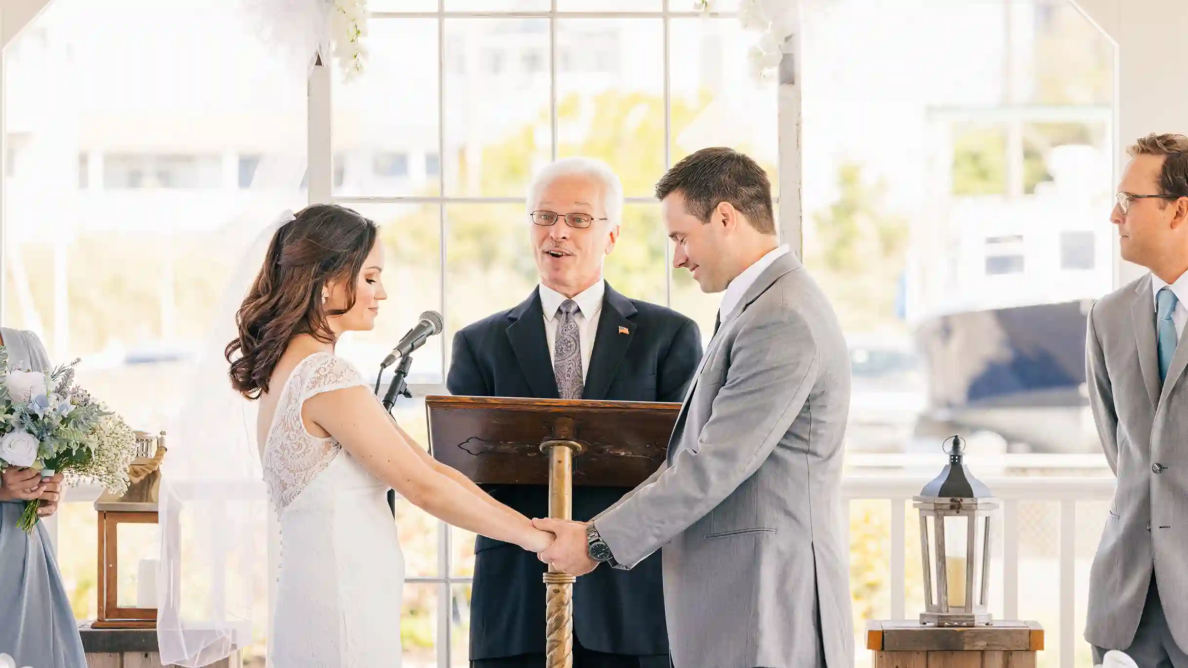 A newly married couple, bathed in warm light, shares a moment of quiet contentment at the altar.