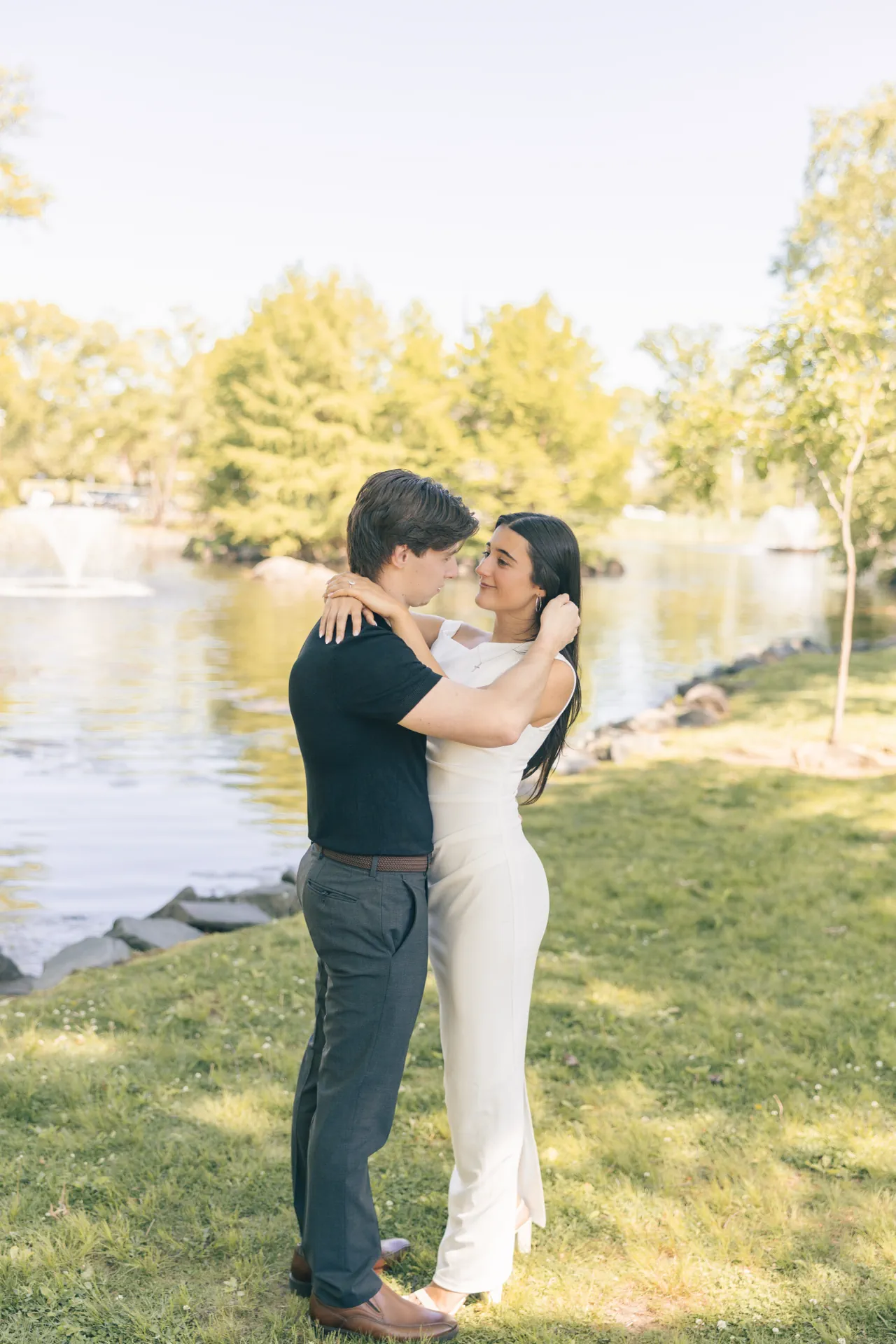 romantic-couple-embracing-by-park-pond-fountain