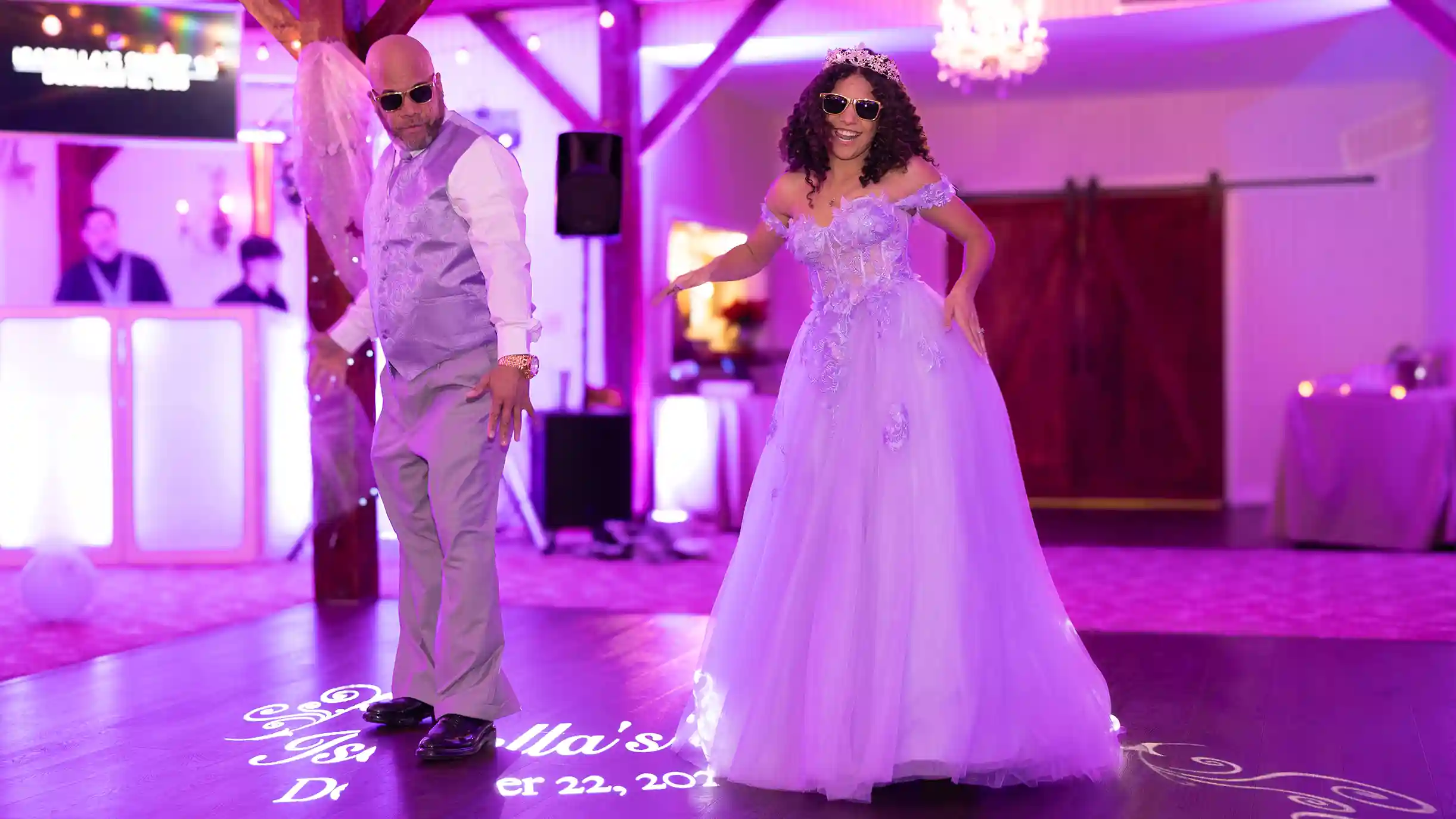 The father of the birthday girl happily dancing with his daughter during their entrance dance.