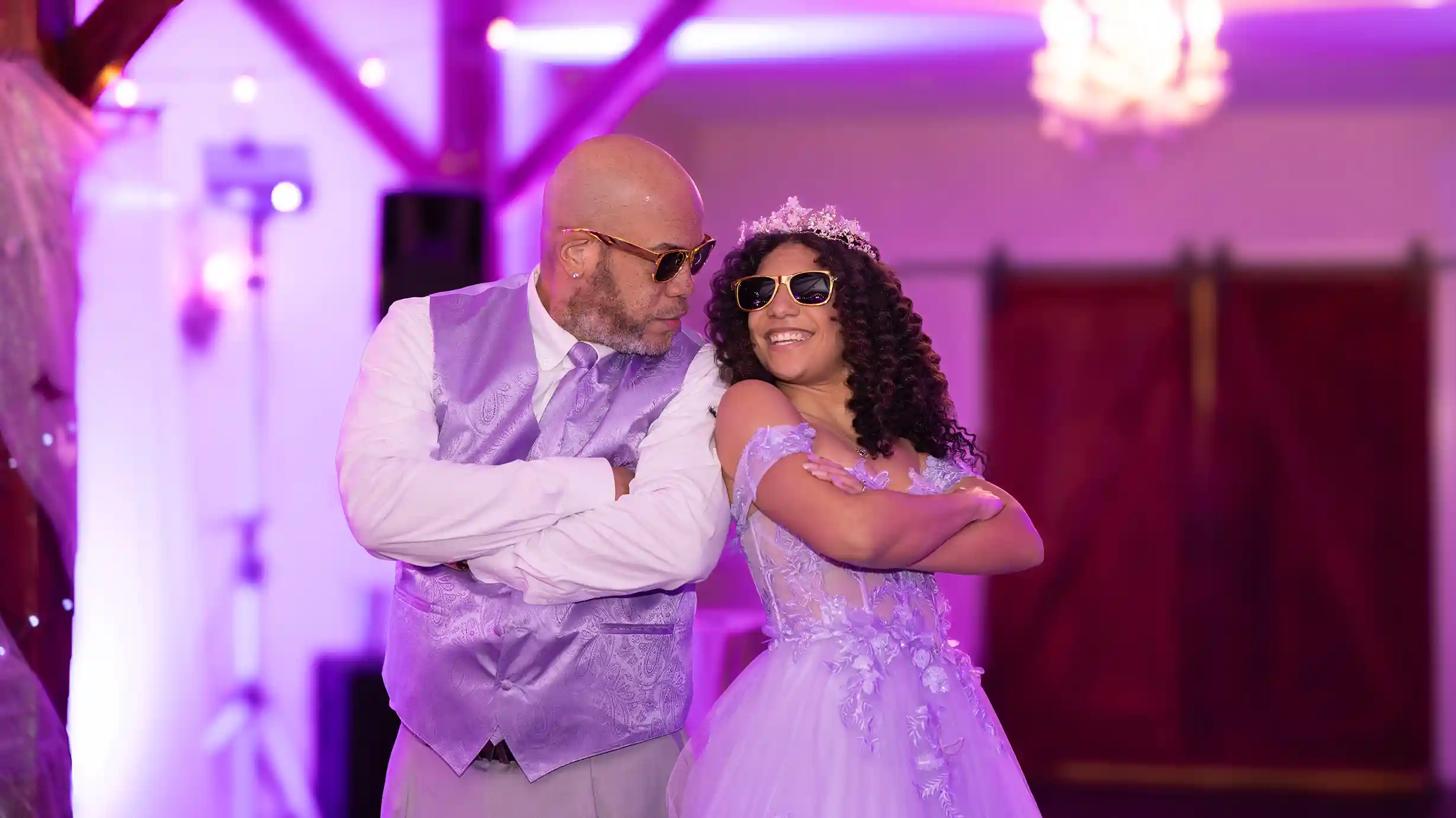 The father of the birthday girl smiling on the dance floor at his daughter and holding a pose after their entrance dance.