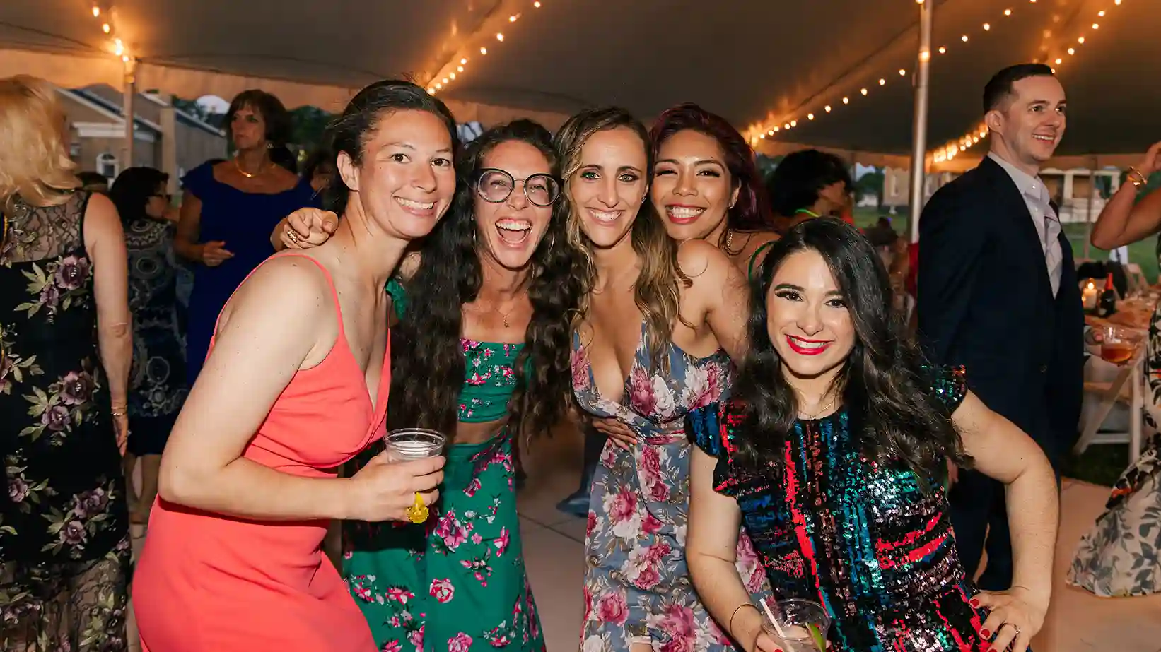 Friends of the bride and groom join together for an action-packed dance floor photo.