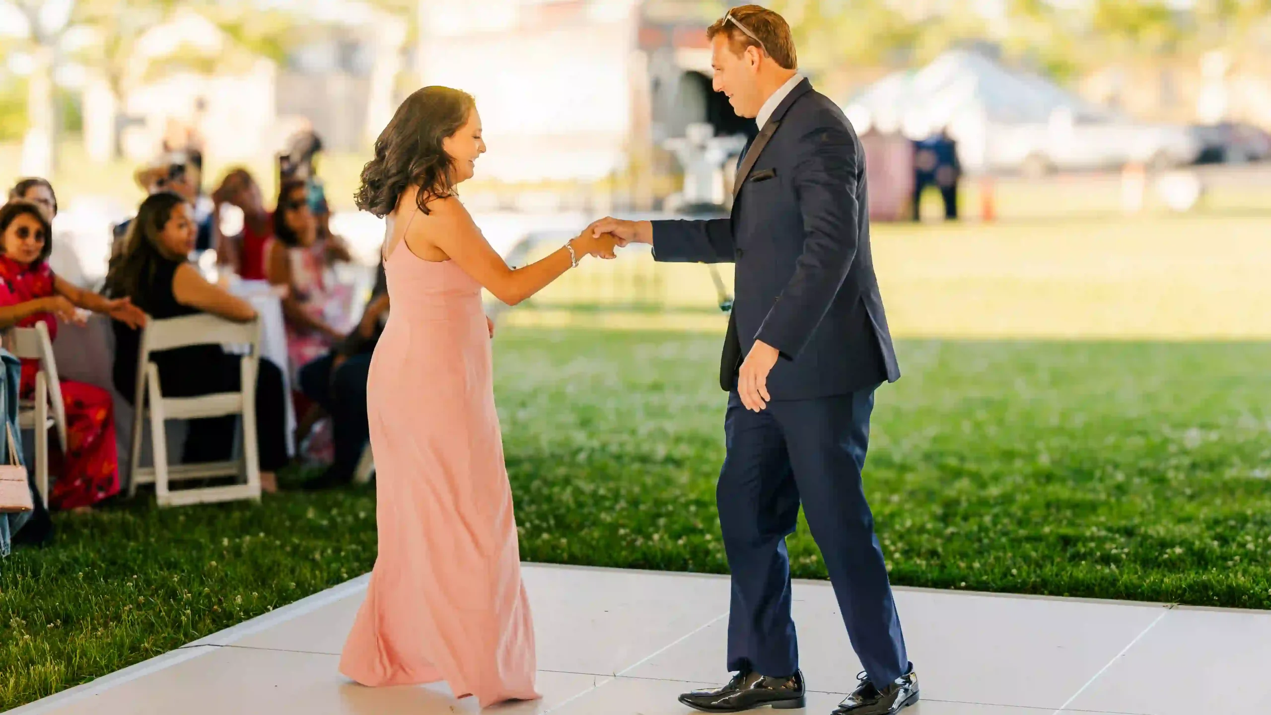 Energetic bridesmaid and groomsman dance their way into the wedding reception.